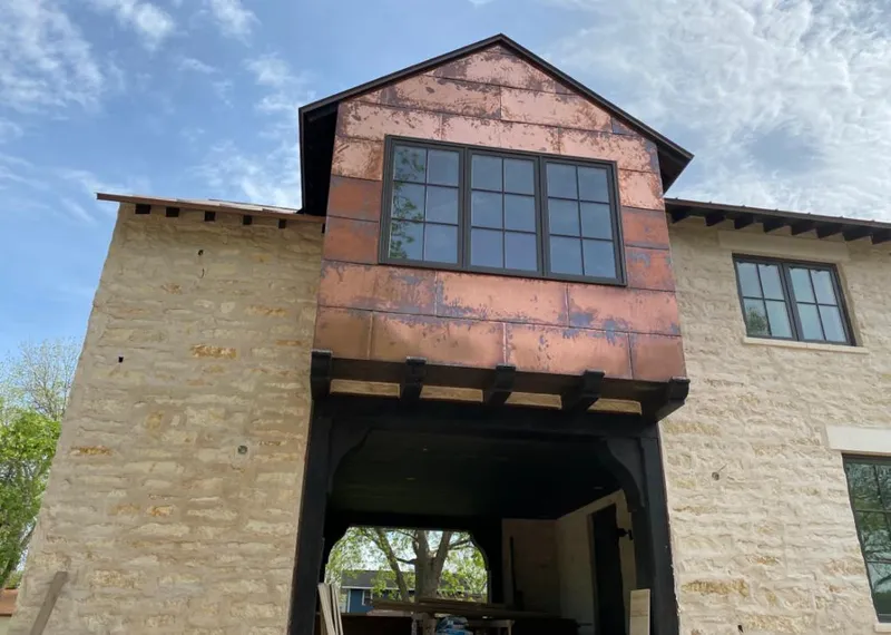 Copper metal panel facade on a stone building for Roof Repair in Watchung